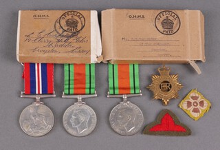 A Defence medal attributable to R.W. Carpenter of 67 The Ridgeway Croydon, in original posting box and with certificate, together with a British War medal and Defence medal in original posting box, with certificate, a Lieutenants pip and an Elizabeth II Army Service Corps cap badge