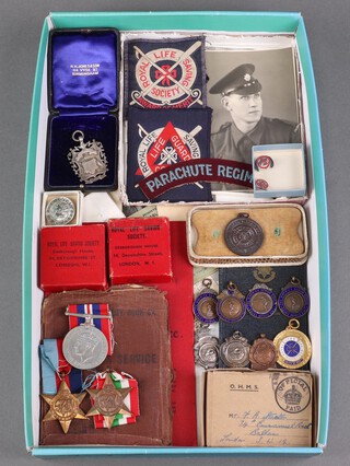 A group of 3 medals attributable to 2665762 Guardsman Frederick Arthur Stanton Coldstream Guards comprising 1939-45 Star, Italy Star, British War medal in original posting box, a Regular Army Certificate of Service Enlisted 22nd February 1943, Discharged 28th October 1945, a Ministry of Labour Disabled Person's Certificate, a George VI Discharge badge, 4 The Warwick Senior School bronze sporting medallions, a soldier's Service Pay Book, an Old Coldstreamers Association Membership card, a Parachute Regt. cloth shoulder title, 2 divisional badges and various photographs of the recipient  