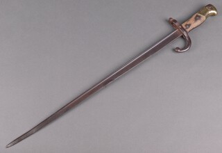 A French model M1874 Gras bayonet with illegible marking to the top of the blade, the wooden grip is bleached 