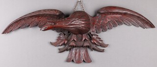 A Royal Flying Corps/Royal Airforce carved mahogany wall plaque in the form of eagle wings outstretched 34cm h x 90cm w