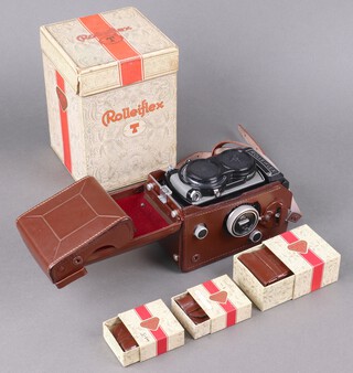 A Rollei Rolleiflex model T1 twin lens reflex camera, serial 2124927 circa 1960, Syncro Compur shutter and Carl Zeiss Oberkochen Tessar 1:3.5 f=75mm lens, in grey leatherette with fitted brown leather case, lens cap, all in original model T box, together with 3 boxed Rollei accessories in fitted leather cases light yellow filter/medium yellow filter/lens hood box.