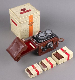 A Rollei Rolleiflex model 2.8f twin lens reflex camera, serial 2425479 circa 1962, Syncro Compur shutter and Carl Zeiss Planar 1:2.8 f=80mm lens, with fitted brown leather case, lens cap, all in original model 2.8F box with instructions, together with 3 boxed Rollei accessories in fitted leather cases green filter/light yellow filter/lens hood
