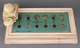 Ede Electrician Epsom, a 12 aperture servants bell indicator board - back door, front door, dining room, drawing room, sitting room, bathroom, bedrooms 1 - 5 and a blank aperture, contained in a white painted wooden frame 10cm h x 53 cm w x 28cm d together with a double bell internal door bell 