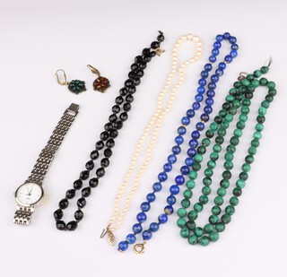 A strand of cultured seed pearls with a 9ct gold clasp, 46cm, a malachite bead necklace, a lapis lazuli bead necklace, a pair of earrings and a wristwatch 