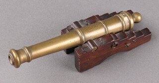 H.M.S Royal George, a brass model table cannon raised on a stepped oak gun carriage (missing lower base/wheels).  The 19cm cannon inscribed "Relic of the Royal George, Sunk 1782, Raised 1840". The Royal George sunk off Portsmouth in 1782 with the loss of 800 men, much of the later salvage and debris was turned into souvenirs.  See lot 489 for another.