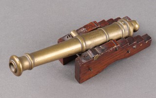 H.M.S Royal George, a brass model table cannon raised on a stepped oak gun carriage (missing lower base/wheels).  The 19cm cannon inscribed "Relic of the Royal George, Sunk 1782, Raised 1840".  The Royal George sunk off Portsmouth in 1782 with the loss of 800 men, much of the later salvage and debris was turned into souvenirs. See lot 488 for another.

