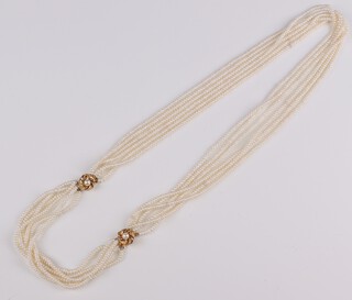 A multi string of seed pearls, the clasp marked silver 