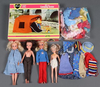 Three late 1970's Sindy dolls, with a quantity of associated outfits including Autumn Days (1977), Funtime Sindy  (1977 red and blue colourways), Romany Girl - variation (1977), Cold and Frosty (1978), Dinner Date (1979) and other clothing, a Sindy Camping Scene set (boxed, incomplete) and one other doll