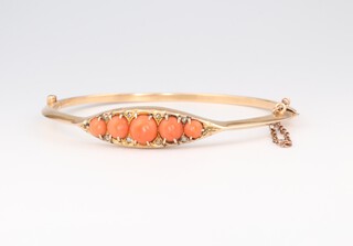 A Victorian yellow gold, testing as 14ct, bangle set 5 coral stones, gross weight 10.15 grams 