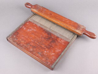 A 19th Century mahogany and brass pill roller 32cm x 31cm 