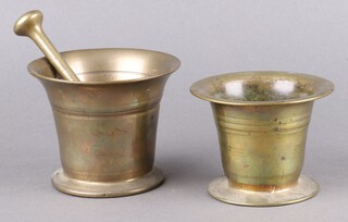 Two 18th Century brass mortars 10cm x 13cm and 11cm x 14cm together with a pestle