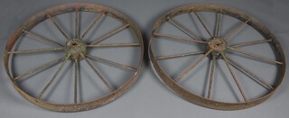A pair of 19th Century iron 12 spoked wheels 111cm diam. x 10cm w 