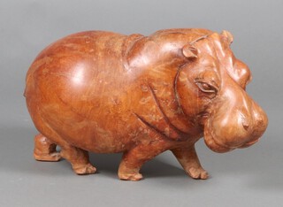 An African carved hardwood figure of a hippopotamus 34cm h x 58cm x 29cm 