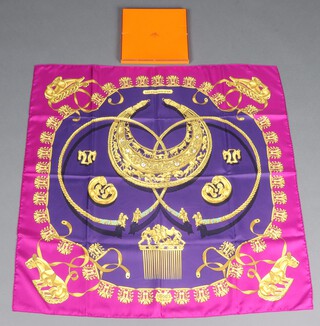 A Hermes "Les Cavaliers "D'Or" silk scarf, designed by Vladimir Rybaltchenko, featuring designs inspired by Scythia gold jewellery and with hand rolled edges 89cm x 89cm, complete with original box, tissue lining and Hermes care instruction card 