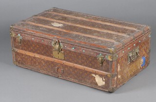 Louis Vuitton, a 1920's Louis Vuitton twin handled cabin trunk with fitted and fabric lined interior, the internal lock stamped with the serial number 206866, the interior with Louis Vuitton label, 149 New Bond Street London, the interior tray missing 2 dividers, 33cm h x 54 cm w x 54cm d, fragment of old paper label to the top, fragments of luggage labels to both sides and front, the brass handles to the side marked Rue Scribe Paris Louis Vuitton, 149 New Bond Street, Made in France 