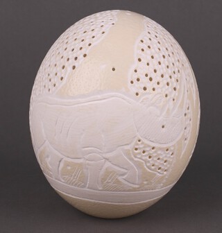 A carved and pierced ostrich egg decorated a rhinoceros 15cm 