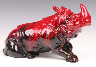 A Royal Doulton veined flambe figure of a seated rhinoceros, designed by Leslie Harradine, the base marked PD, 24cm h x 39cm w 