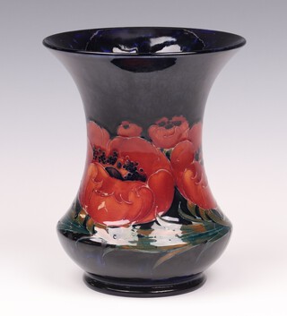Walter Moorcroft, a poppy vase on a blue ground, of waisted form, impressed marks and signed 17.5cm 