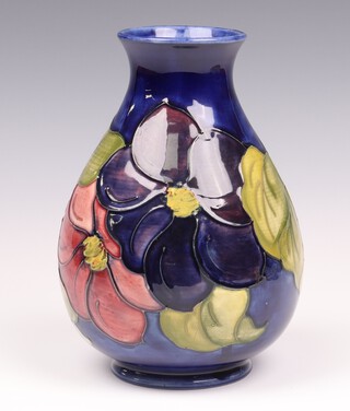 A Moorcroft Clematis vase with a blue ground, signed and impressed marks  20cm 