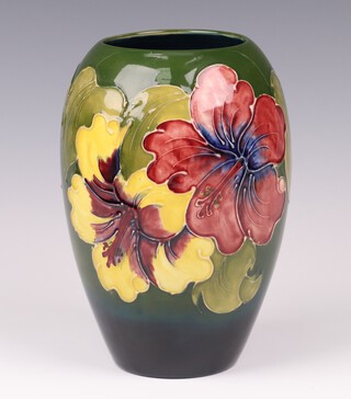 A Walter Moorcroft Hibiscus pattern ovoid vase on a graduated green and blue ground, circa 1974, initialled and impressed marks 18cm 