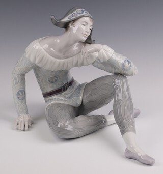 A Lladro figure of Nostalgia Harlequin from the Utopia range, printed and impressed marks to base, dated 2005, 22cm high x 30cm w, boxed, model 01008249 by Jose Javier Malavia