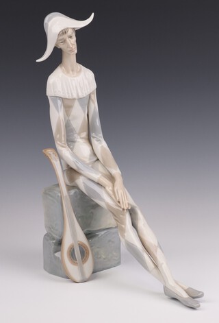 A Nao figure of a seated harlequin with mandolin, base incised E19J 34cm 