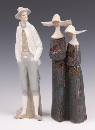 A Lladro figure of a standing gentleman with hands in pockets, base incised 13 and with biro mark Nov '76 36cm together with a Lladro gres figure of 2 standing nuns 33cm 