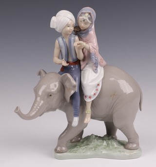 A Lladro figure group "Hindu Children" sat on an elephant base impressed 5352 24cm, boxed