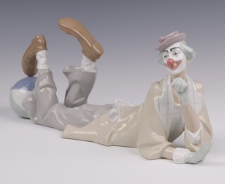 A Lladro figure of a clown laying down with ball at feet, base impressed 4618 39cm long 