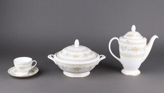 A Minton Broadlands pattern 57 piece dinner/tea service, comprising 2 twin handled tureens and covers, 10 side plates, 10 tea plates, sauce boat and stand, coffee pot, milk jug (cracked), 1 coffee can, 11 saucers, 8 tea cups, 10 saucers (1 cracked) and a lid 