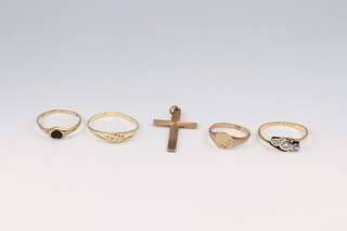 A yellow gold, marked 18ct, dress ring set illusion diamonds, size M 1/2 1.64 grams, a 9ct gold cross 1.32 grams, a 9ct yellow gold ring (misshapen) set a hardstone 0.90 grams and 2 other 9ct gold rings 1.74 grams (both misshapen) 