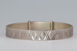 An engraved silver bangle 22.5 grams 