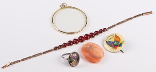 A lady's yellow gold testing as 9ct bracelet, set red glass stones, 18cm, 3.13 grams gross, a silver dress ring with butterfly wing bonneted lady, a commemorative badge etc