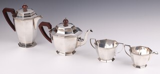 An Art Deco silver 4 piece tea service of octagonal form comprising teapot, hot water jug both with wooden handles, twin handled sugar bowl and cream jug, Birmingham 1934 with Jubilee hallmark, Owen and Booth, gross weight 1408 grams