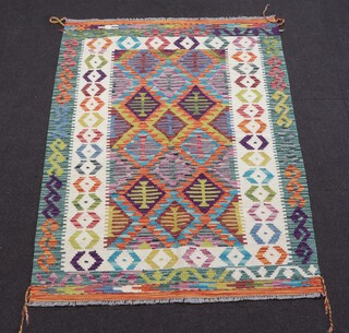 A white, green and turquoise ground Chobi Kilim rug with diamond medallions to the centre, within geometric borders 153cm x 110cm 