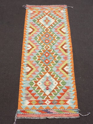 A yellow, green and turquoise ground Chobi Kilim runner with 4 diamonds to the centre 203cm x 63cm 