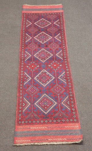 A red and blue ground Meshwani runner with 5 diamonds to the centre 247cm x 64cm