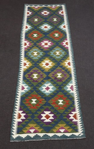 A blue, green and white ground Maimana Kilim runner with overall diamond design 298cm x 79cm 