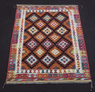 A brown, black and green ground Maimana Kilim rug with all over geometric design 188cm x 122cm 
