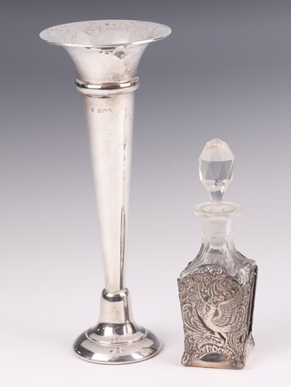 A silver trumpet shaped specimen vase Birmingham 1969, 20cm, together with a cut glass bottle contained in a pierced and embossed silver plated mount 