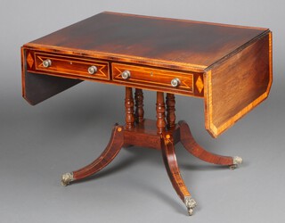 A Regency rosewood crossbanded satinwood pedestal sofa table, fitted 2 drawers, raised on 4 turned columns with a platform base and outswept supports ending in brass caps and casters 71cm h x 90cm w x 68cm d 