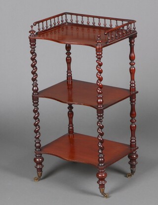 A Victorian mahogany 3 tier what-not of serpentine outline, pierced bobbin gallery, raised on spiral supports with brass caps and casters 83cm h x 45cm w x 31cm d 