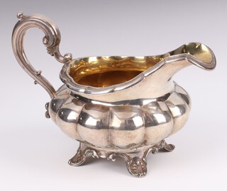 A William IV silver cream jug of melon form and parcel gilt interior, London 1829, maker Edward, Edward Junior, John and William Barnard, 240 grams 