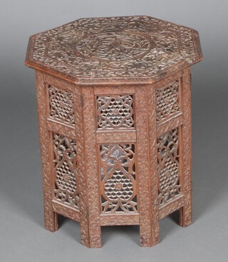 An octagonal carved and pierced Indian hardwood folding occasional table with floral decoration 49cm h x 46cm w x 45cm d  