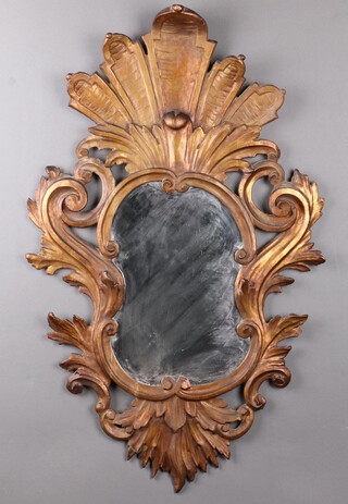 An 18th/19th Century shaped plate wall mirror, contained in a Rococo style gilt carved and painted wooden frame 102cm x 62cm 