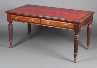 A Victorian mahogany library table with red inset writing surface, fitted 2 drawers, raised on turned and reeded supports 77cm h x 152cm w x 81cm d  
