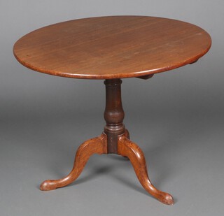A 19th Century circular oak and elm snap top tea table, raised on a bulbous turned column with tripod base 70cm x 91cm diam. 