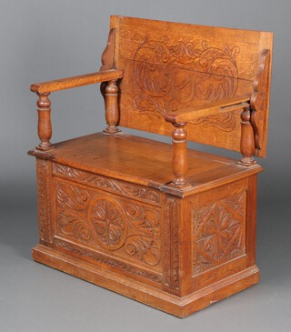A Victorian carved light oak monks bench with hinged lid 79cm h x 91cm w x 50cm d 