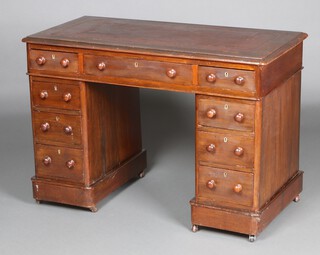 A mahogany and pine kneehole desk with brown leather writing surface, fitted 1 long and 8 short drawers 72cm h x 106 cm w x 52cm d 