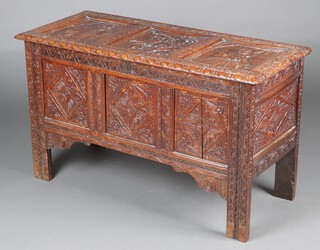 An 17th/18th Century carved elm and oak coffer, constructed from old timbers,  the interior fitted a candle box with replacement handles, the later carved lid with portrait of Henry VIII, Queen Mary of Scots and Charles I, 65cm h x 114cm w x 47cm d 